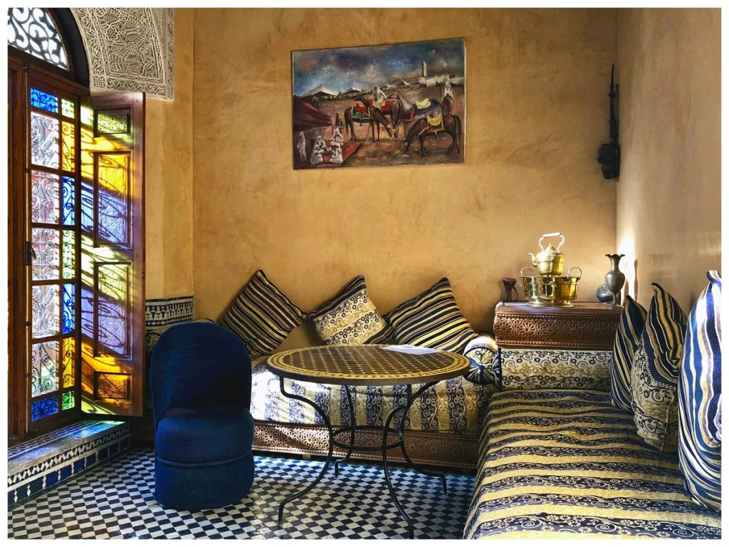 Lounge and window with stained glass at Riad Layalina Fes
