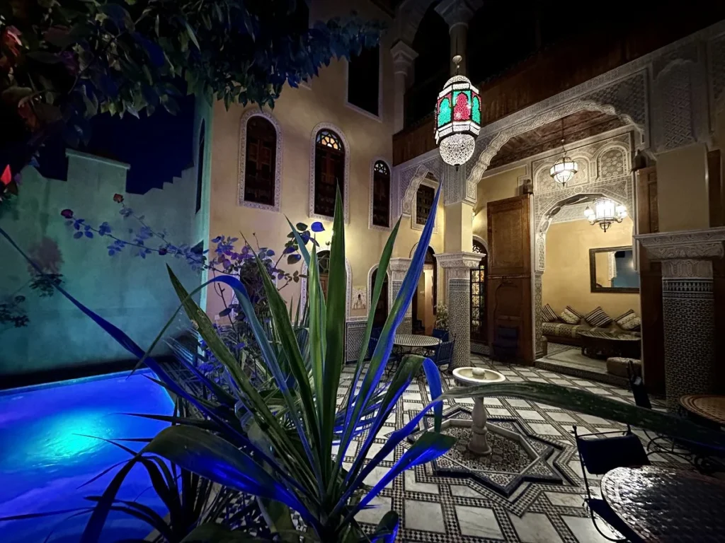 Patio and pool by night at Riad Layalina Fez