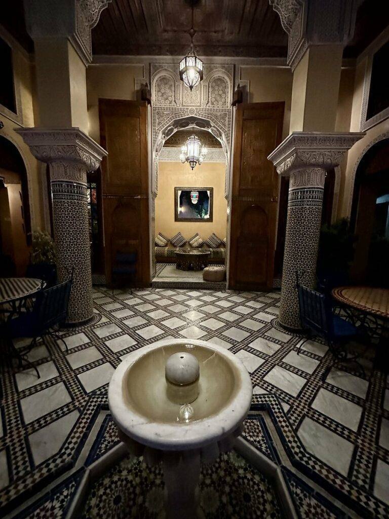 Patio and fountain by night at Riad Layalina Fez