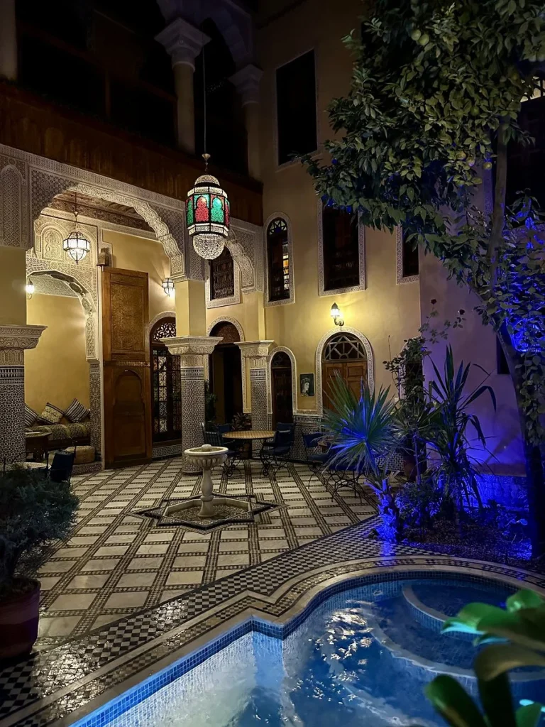 Patio and pool by night at Riad Layalina Fes